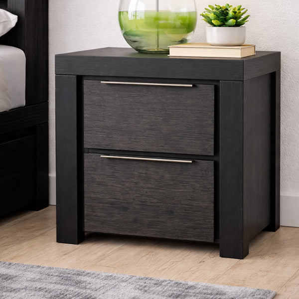Black nightstand with two drawers, decorative items on top, in a bedroom setting.