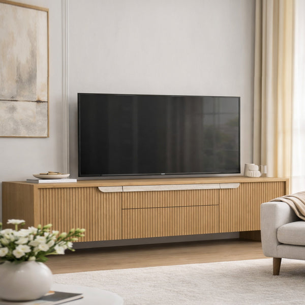Modern living room with a wooden TV stand and a large flat-screen TV.