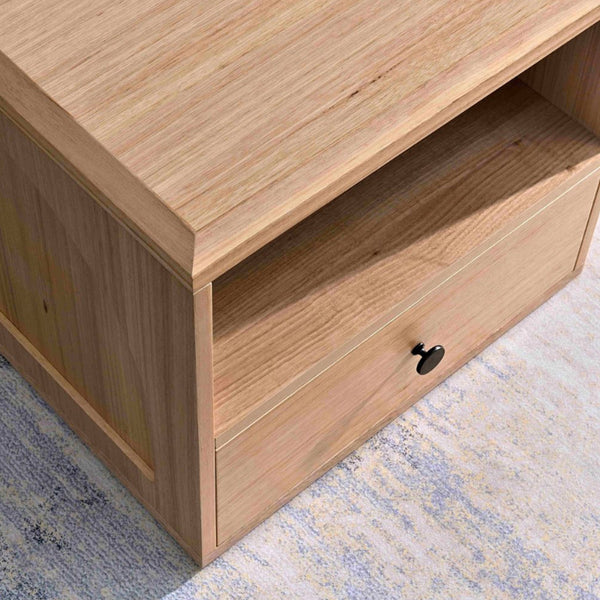 Light wood drawer front with black oval pull and visible wood grain details