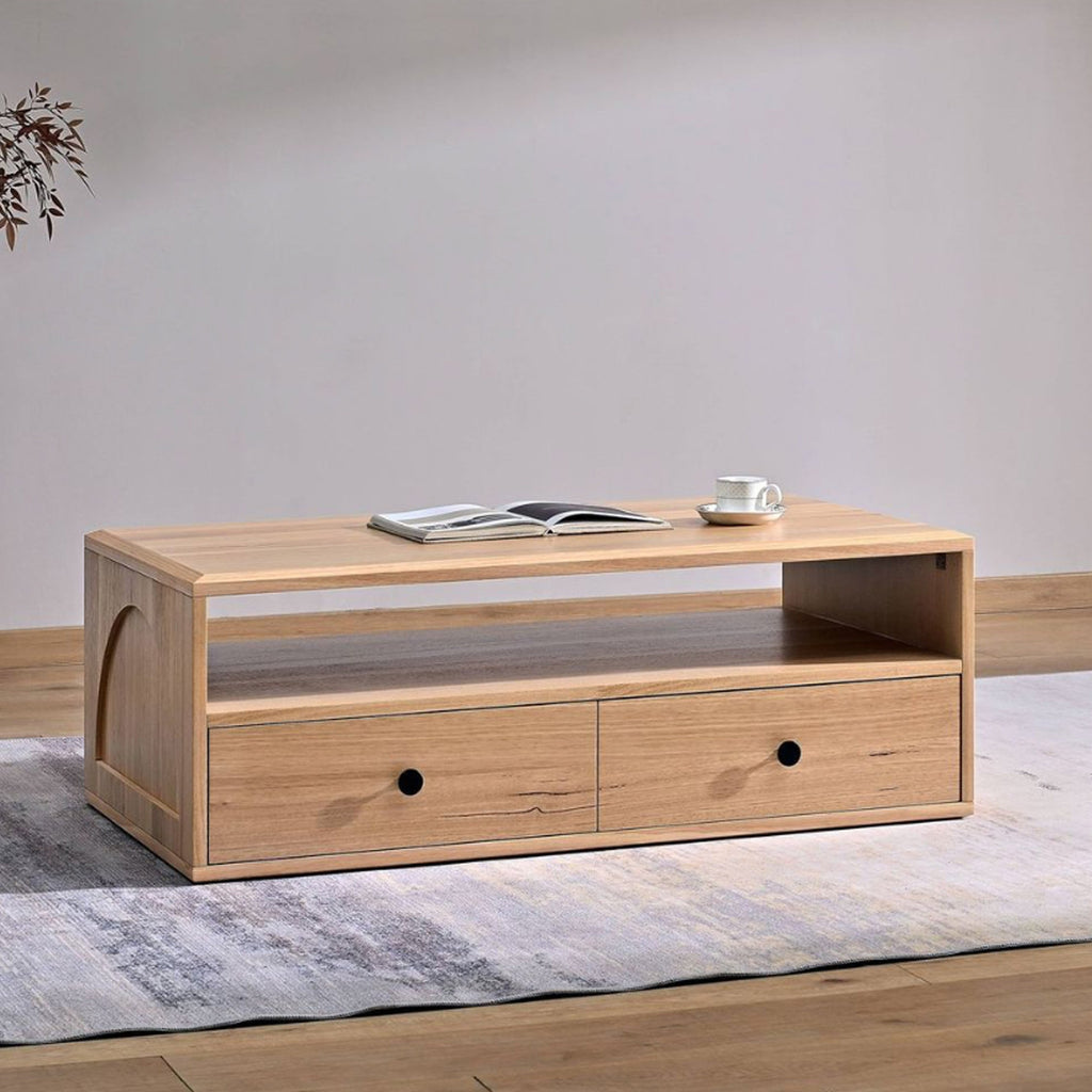 Light wood coffee table with open shelf and two front drawers, each with black knobs