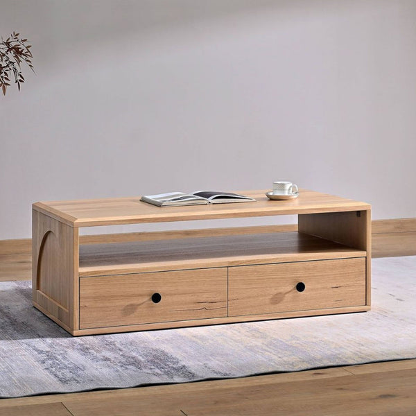 Light wood coffee table with open shelf and two front drawers, each with black knobs