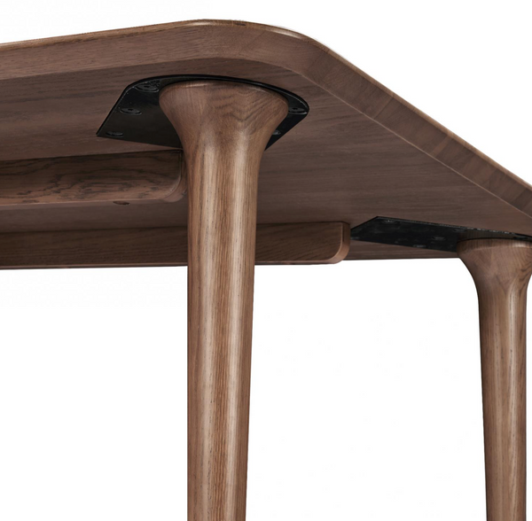 Walnut dining table with thick pedestal base and angled tabletop edge
