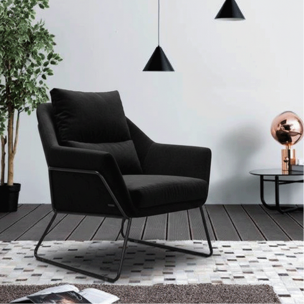 Black velvet accent chair with cushioned seat and backrest on metal sled legs