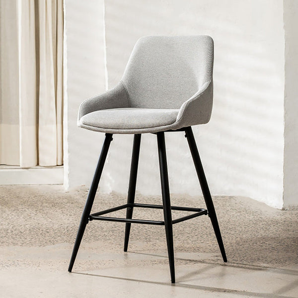 Light grey fabric bar stool with black legs and footrest, curved backrest