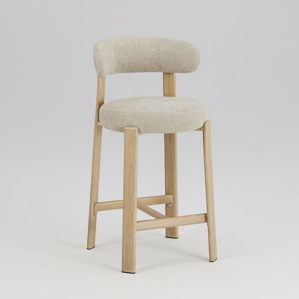 Bar stool with beige cushioned seat and backrest on a light gray background