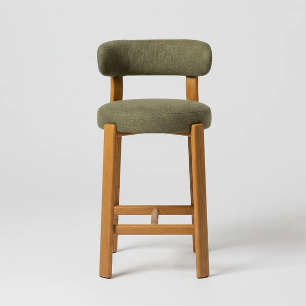 A modern bar stool with an olive green upholstered seat and backrest, supported by a light natural wood frame, shown against a neutral light gray background.