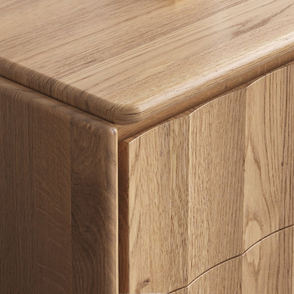 Light wood corner detail with rounded edge and panel seam.