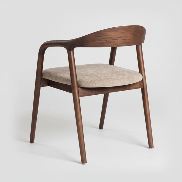 A mid-century modern dining chair with a curved dark brown wooden frame, armrests, and a light beige textured fabric seat cushion, shown on a light gray studio background.