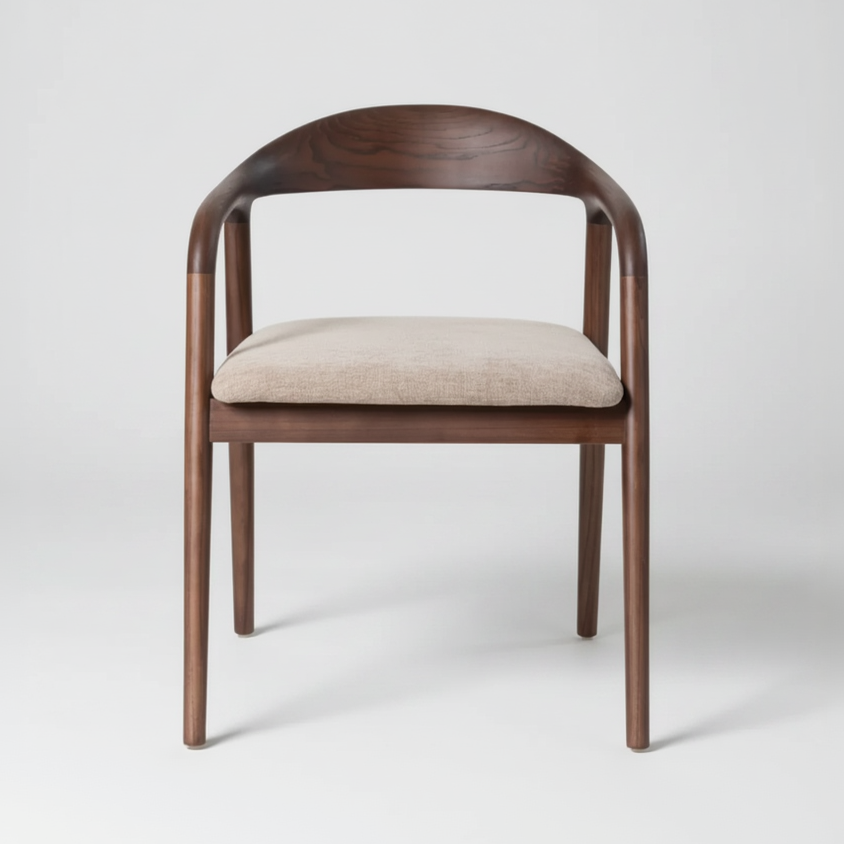 A modern wooden dining chair with a curved backrest, slim tapered legs, and a light beige upholstered seat cushion, shown against a neutral light gray background.