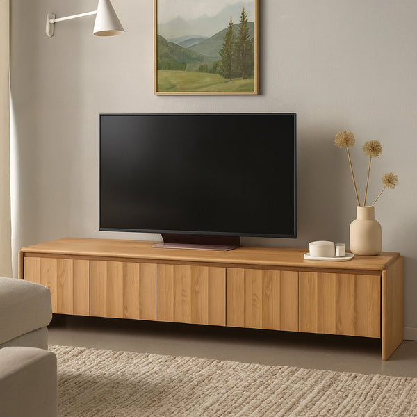 Light oak TV unit console with paneled doors and black flat-screen TV