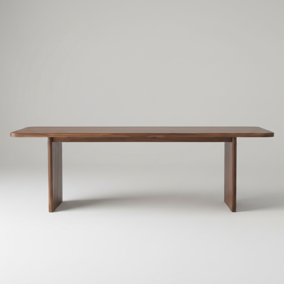 A modern rectangular wooden table with a medium brown finish, featuring fluted pedestal legs, shown against a solid white background.