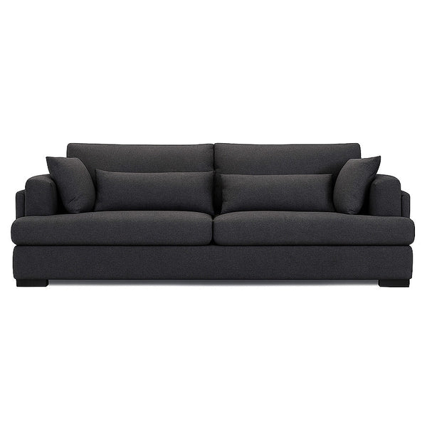 Charcoal grey fabric sofa with tufted back cushions and low profile