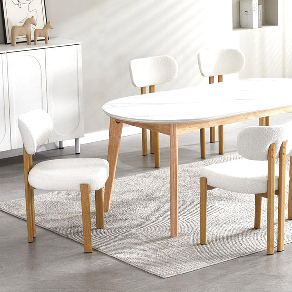 Beige fabric dining chair with rounded back, padded seat, and light wood legs