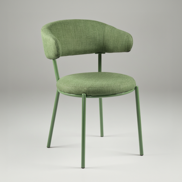 An upholstered dining chair with a curved backrest and a round seat cushion in a textured sage green fabric, supported by a matching sage green metal frame with four legs, shown against a plain white background.