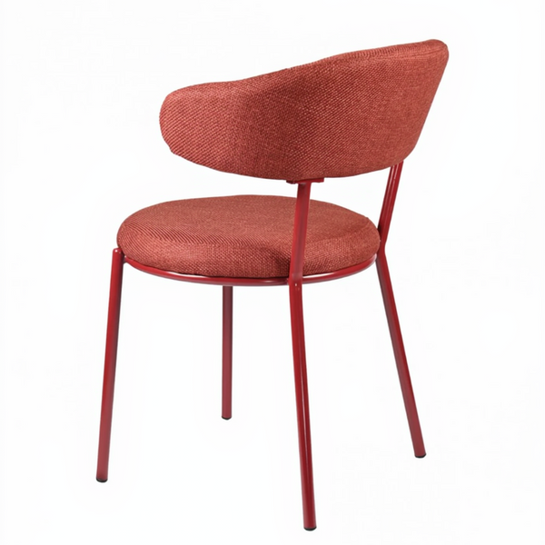A modern dining chair with a rounded, upholstered backrest and seat cushion in a textured terracotta fabric, supported by slim metal legs in a matching reddish-brown finish, shown on a plain white background.