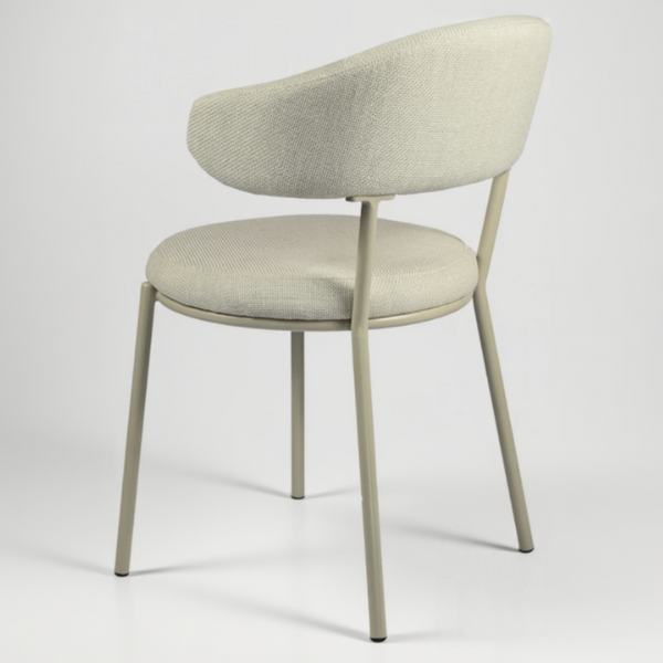 A modern upholstered dining chair with a curved backrest and seat cushion in a light beige textured fabric, supported by slim light gray metal legs, shown against a neutral light gray background.