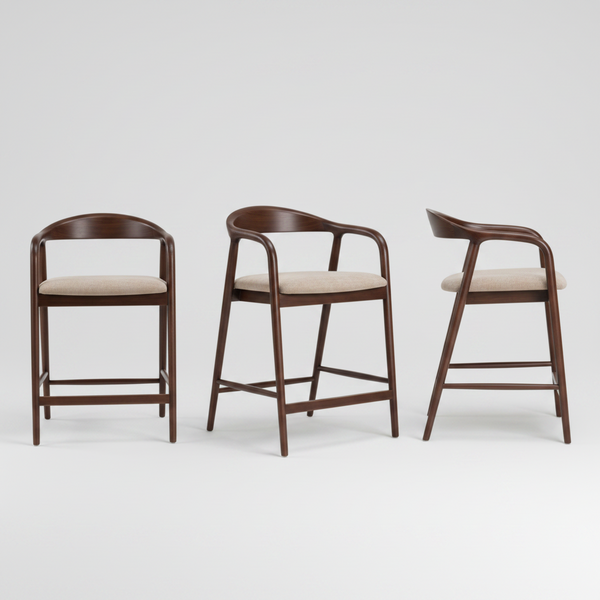A modern counter stool with a curved dark brown wooden frame, armrests, and a light beige upholstered seat cushion, shown against a plain white background.