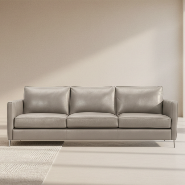 Light-colored leather 3-seat sofa with three padded back cushions and track arms