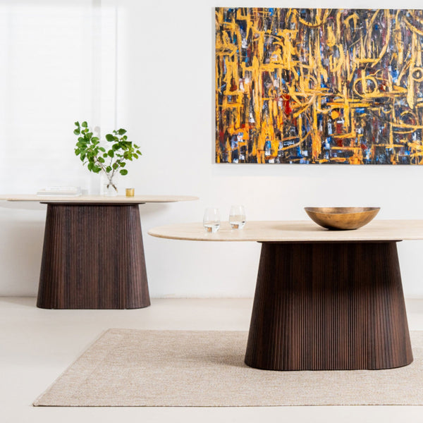 Round dining table with dark ribbed pedestal base