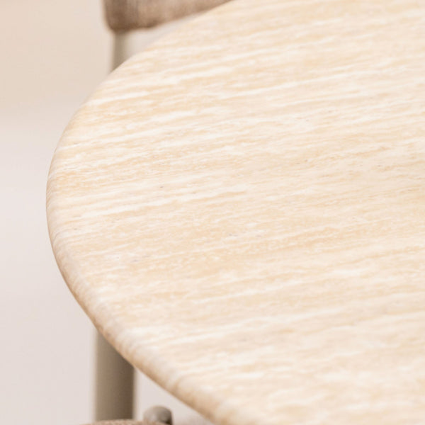 Round dining table tabletop close-up with light wood grain finish