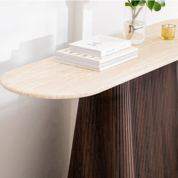 Round accent table with light wood top and dark fluted pedestal base, angled view