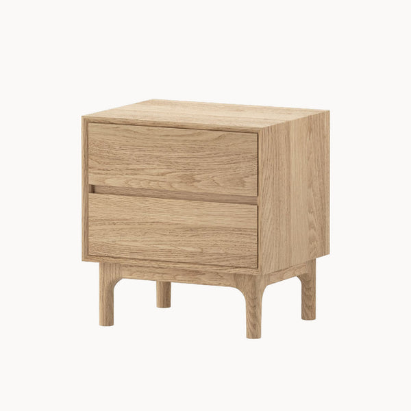 Light oak nightstand with two drawers and tapered legs, shown from a side angle