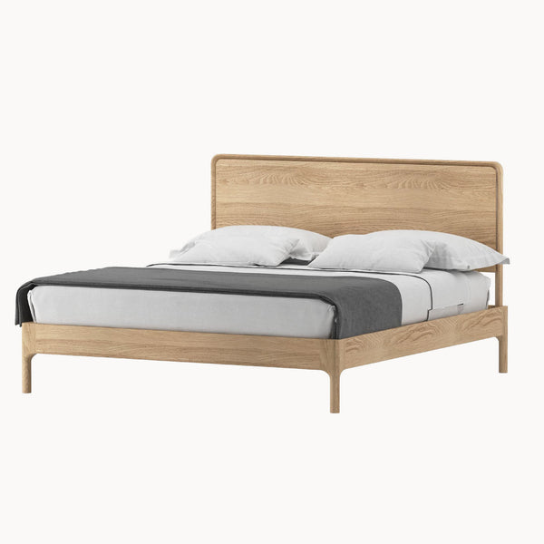Light oak platform bed frame with tall headboard, gray base, and white pillows