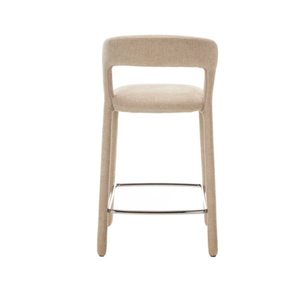 Beige fabric bar stool with padded seat, curved back, and metal footrest