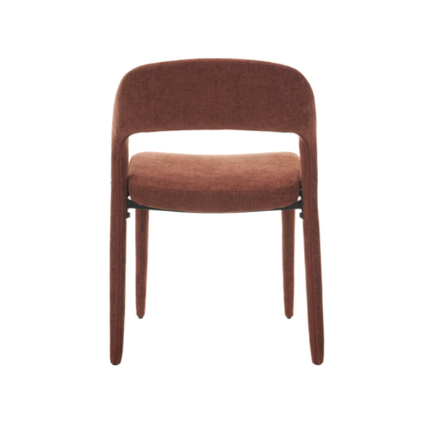 Brick-red upholstered dining chair in side view, rounded seat and tapered legs