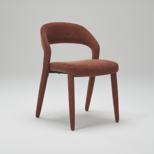 Brick-red upholstered dining chair with rounded seat, curved back, and tapered legs