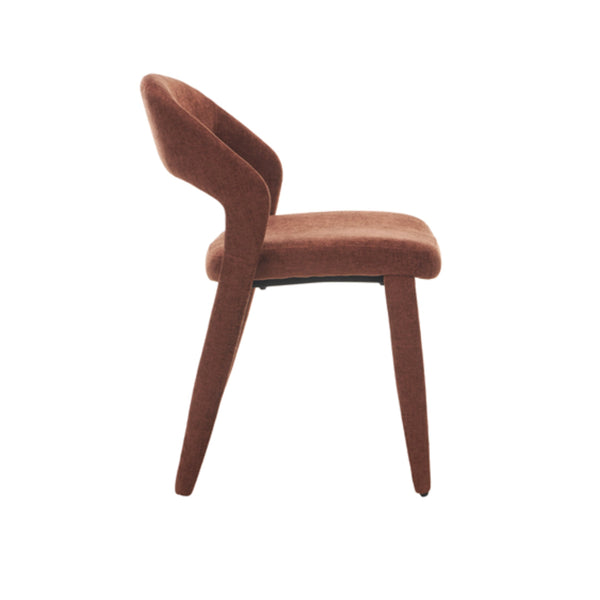 Brick-red upholstered dining chair viewed from rear-left, curved back and tapered legs