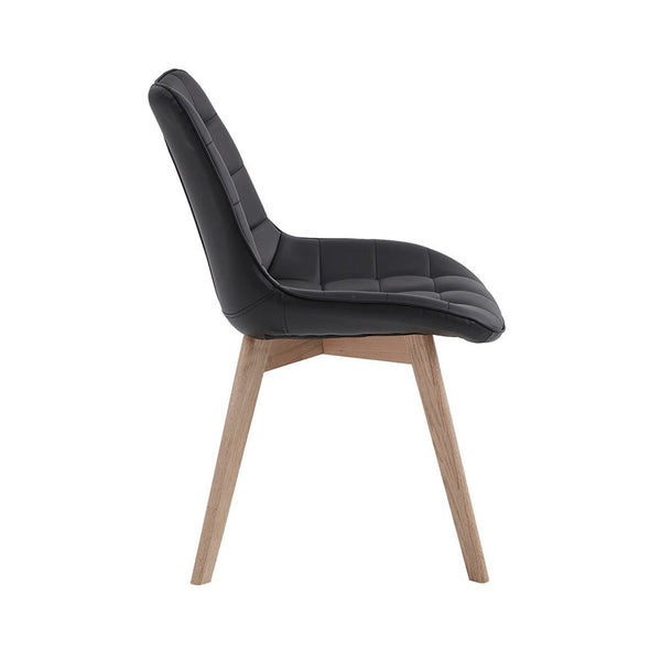 Black dining chair with tufted PU seat, curved back, and light wood legs