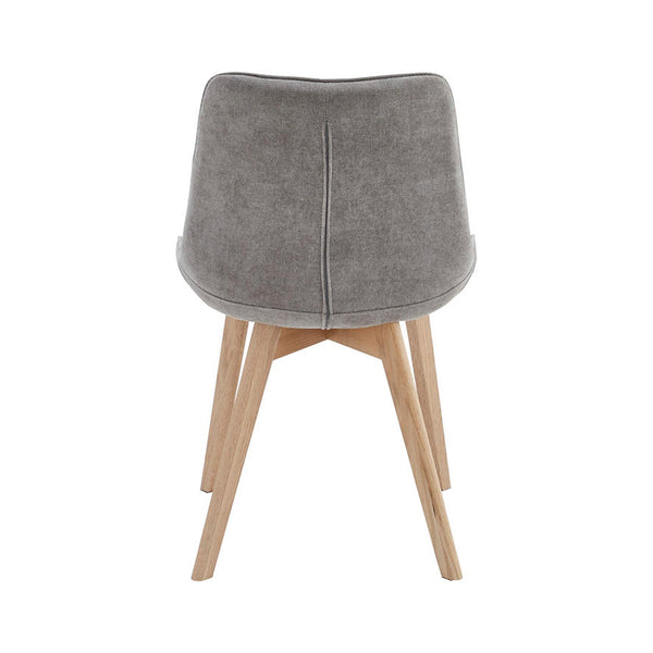 Light grey upholstered dining chair with smooth back panel and tapered wooden legs