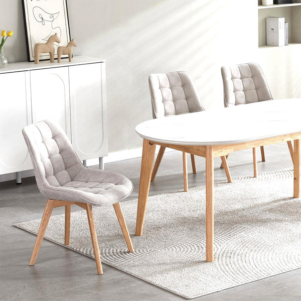 Taupe upholstered dining chair with tufted back, padded seat, and natural wood legs