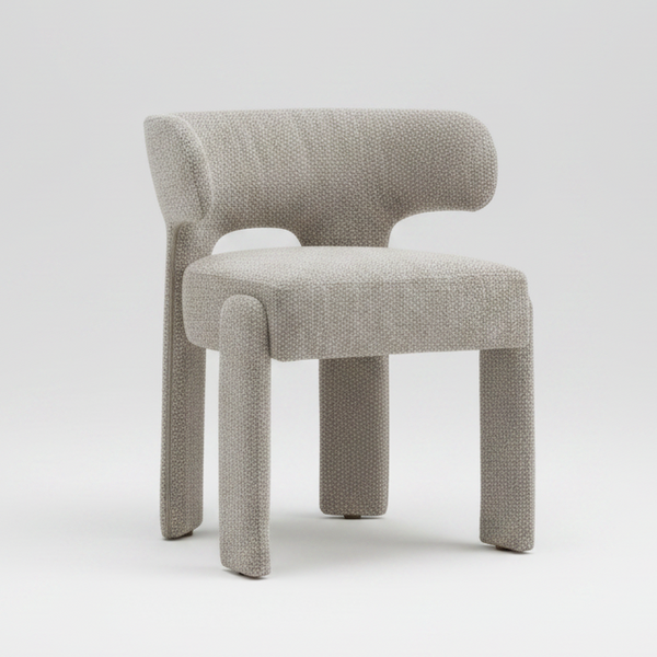 A modern upholstered accent chair with a textured bouclé fabric in a light gray-beige tone, featuring a curved backrest, integrated armrests, and block legs, shown on a plain white background.