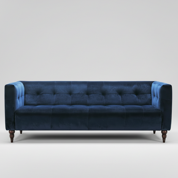 Navy velvet sofa with tufted back, square arms, and tapered wooden feet