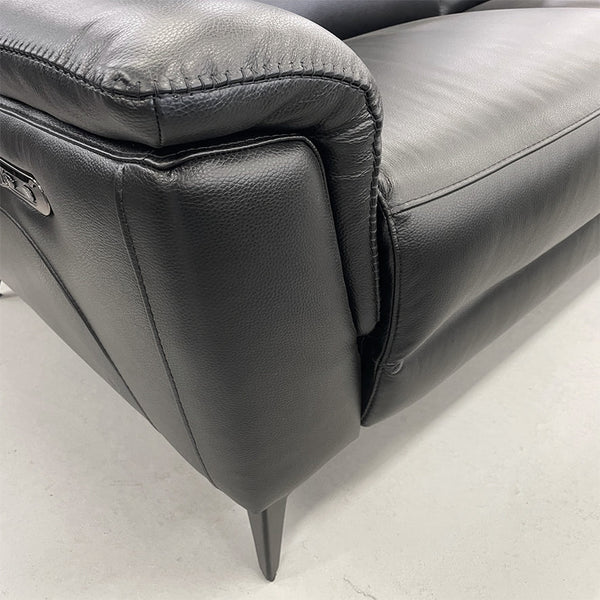 Dark upholstery armrest and seat cushion with stitched seams and tapered legs