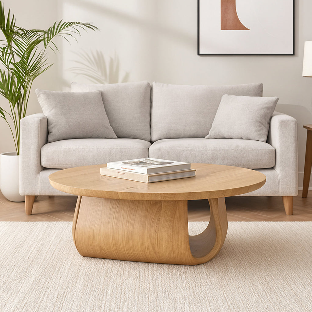 Low-profile natural oak round coffee table with curved pedestal base