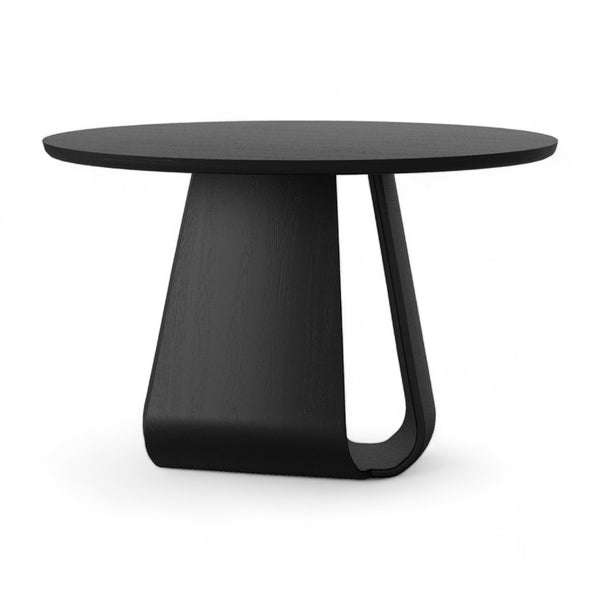 Black round dining table with curved pedestal base