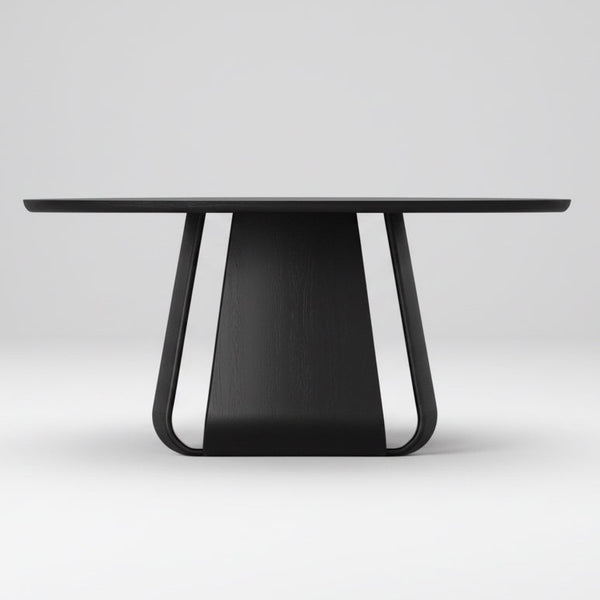 Round black oak dining table viewed from the side, showing tapered pedestal base