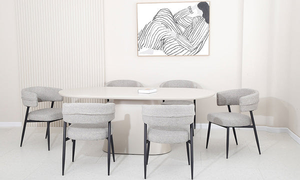 Light gray upholstered dining chairs with black legs around a white table