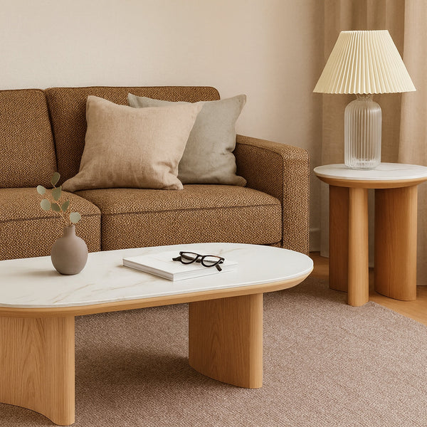 Wood accent lamp table with round marble-look top beside a sofa