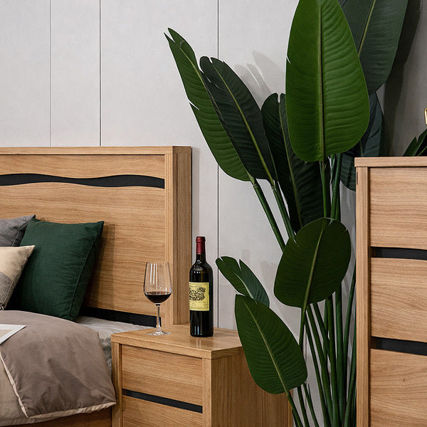 Wood nightstand with two drawers beside a bed frame