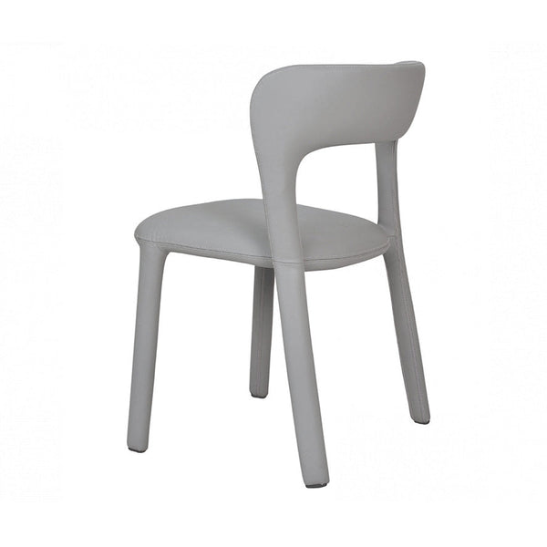 Grey dining chair with rounded backrest, cushioned seat, and four angled legs.
