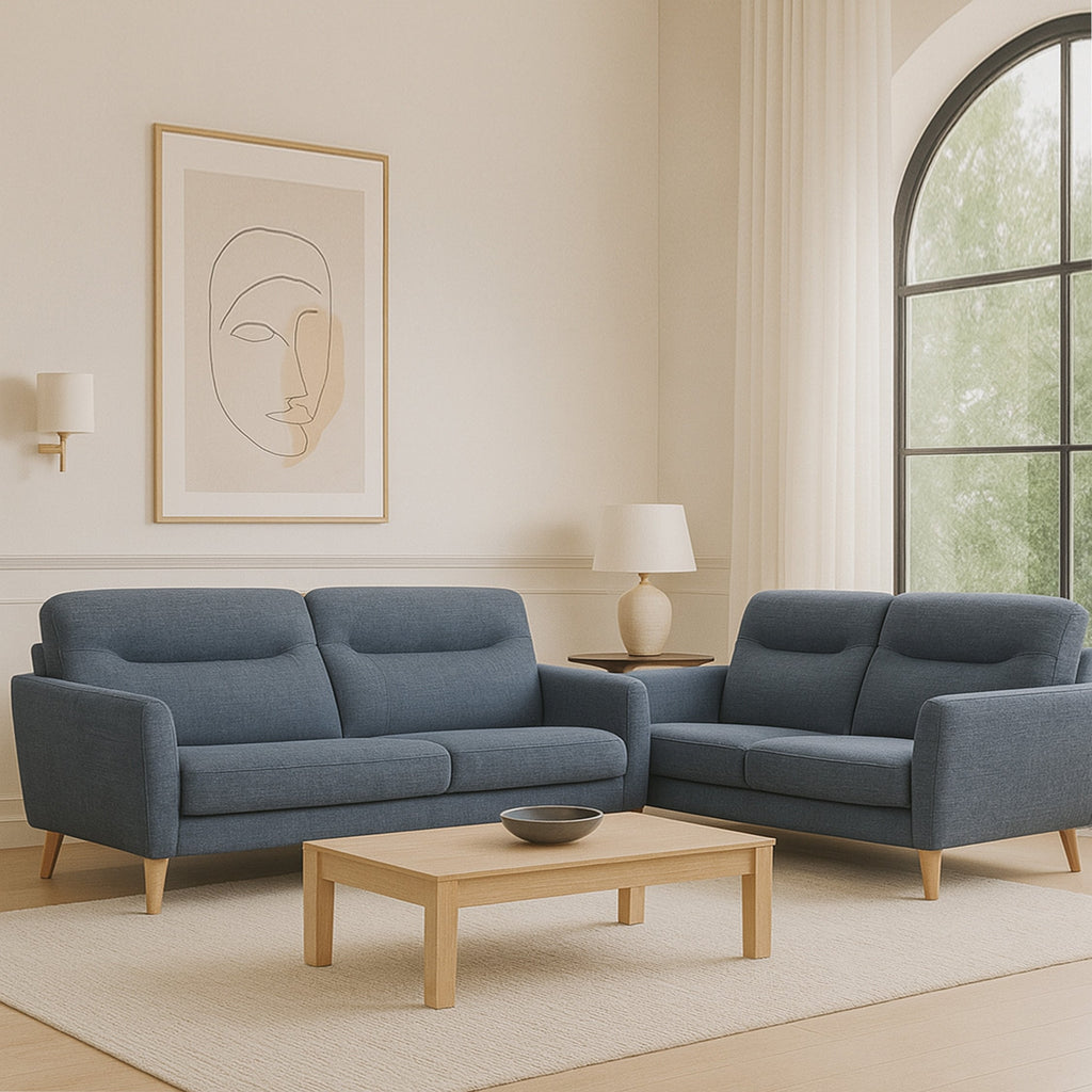 Blue upholstered sofa with deep cushioned back, rounded arms, and wooden legs