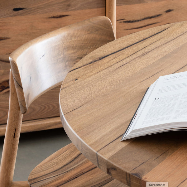Wood dining chair close-up of curved arm/back and smooth seat surface