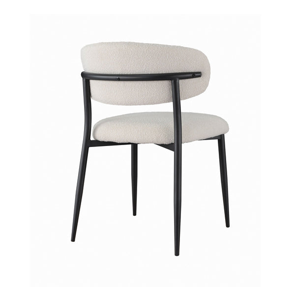 Off-white fabric dining chair with rounded back and cushioned seat, black legs.