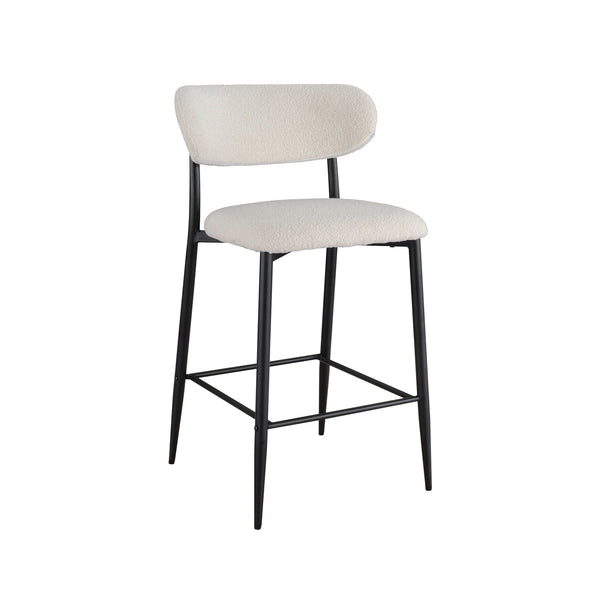 Bar stool with light beige cushioned seat and back, black frame and crossbar footrest