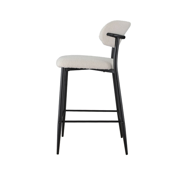 Bar stool side view with light beige padded seat and back, black curved metal legs