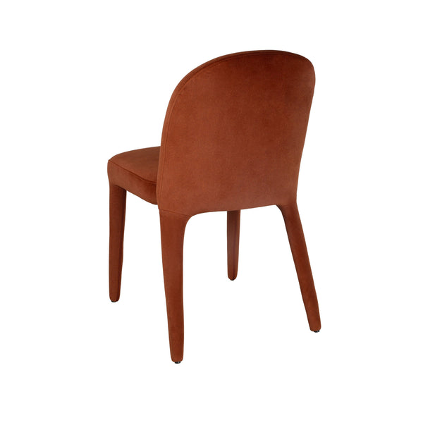 Side view of rust upholstered dining chair with curved back, cushioned seat, wooden legs